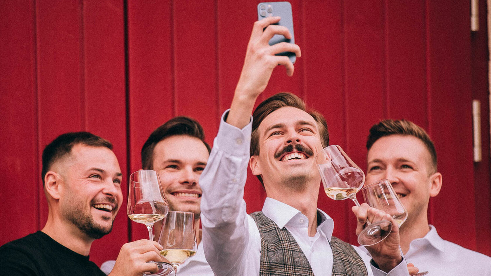 Junge Gruppe macht ein Selfie und trinkt Wein